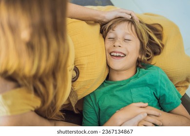 A heartwarming moment: pregnant mother and her older son sit on the sofa, engaging in a tender conversation about the upcoming pregnancy - Shutterstock ID 2367134867