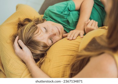 A heartwarming moment: pregnant mother and her older son sit on the sofa, engaging in a tender conversation about the upcoming pregnancy - Shutterstock ID 2367134871