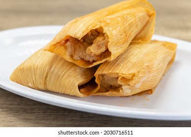 Hearty Appetizer Of Tamales Wrapped In Corn Husks And Fresh From The Oven.