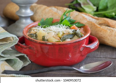 Hearty Beef Barley White Bean Stew And Soup In A Red Crock. Homemade Food That Will Warm You From The Inside Out. Crock Pot Slow Cooking, Wheat French Bread, Seasonal Food Scene.