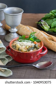 Hearty Beef Barley White Bean Stew And Soup In A Red Crock. Homemade Food That Will Warm You From The Inside Out. Crock Pot Slow Cooking, Wheat French Bread, Seasonal Food Scene.