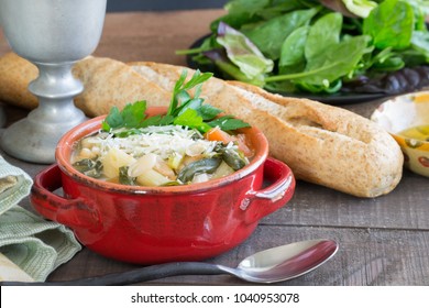 Hearty Beef Barley White Bean Stew And Soup In A Red Crock. Homemade Food That Will Warm You From The Inside Out. Crock Pot Slow Cooking, Wheat French Bread, Seasonal Food Scene.