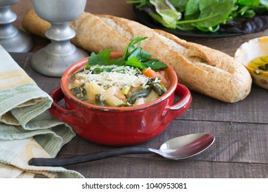 Hearty Beef Barley White Bean Stew And Soup In A Red Crock. Homemade Food That Will Warm You From The Inside Out. Crock Pot Slow Cooking, Wheat French Bread, Seasonal Food Scene.