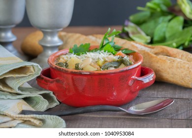 Hearty Beef Barley White Bean Stew And Soup In A Red Crock. Homemade Food That Will Warm You From The Inside Out. Crock Pot Slow Cooking, Wheat French Bread, Seasonal Food Scene.