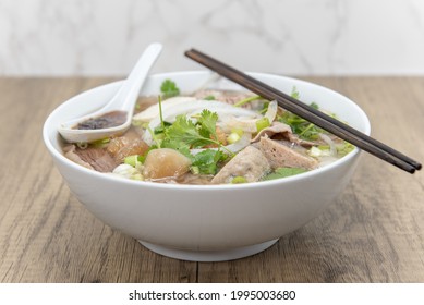 Hearty Bowl Of Pho Loaded With Meat, Broth, And Special Taro Sauce For A Complete Meal.