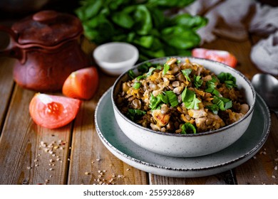 Hearty lunch: Lentils with chicken and vegetables in a beautiful plate on a wooden table. Home cooking. - Powered by Shutterstock