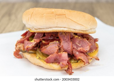 Hearty Pastrami Sandwich Loaded In Between Toasted Buns And Any Toppings Or Condiments Desired.