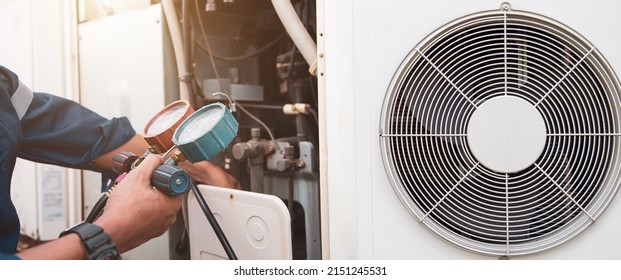 Heat And Air Conditioning, HVAC System Service Technician Using Measuring Manifold Gauge Checking Refrigerant And Filling Industrial Air Conditioner After Duct Cleaning Maintenance Outdoor Compressor.