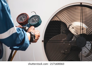 Heat And Air Conditioning, HVAC System Service Technician Using Measuring Manifold Gauge Checking Refrigerant And Filling Industrial Air Conditioner After Duct Cleaning Maintenance Outdoor Compressor.