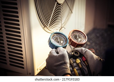 Heat And Air Conditioning, HVAC System Service Technician Using Measuring Manifold Gauge Checking Refrigerant And Filling Industrial Air Conditioner After Duct Cleaning Maintenance Outdoor Compressor.