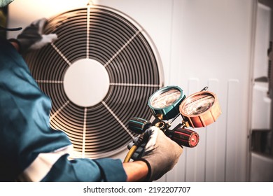 Heat And Air Conditioning, HVAC System Service Technician Using Measuring Manifold Gauge Checking Refrigerant And Filling Industrial Air Conditioner After Duct Cleaning Maintenance Outdoor Compressor.