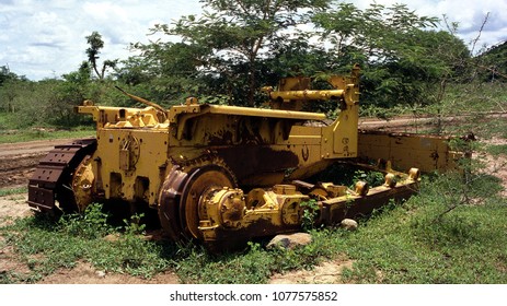 Heat Damaged Fast Reversal Film. Pictures From The Mid-90's Of N.E. Nigeria. An Abandoned Overgrown Rusty Grading Machine Contrasts Against It's Original Yellow.