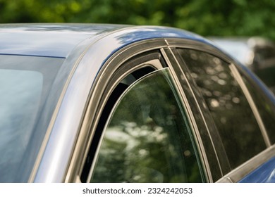 Heat, high temperature concept. Closeup of slightly ajar car window for better cooling on hot summer day. Opened vehicle window for air circulation in warm weather