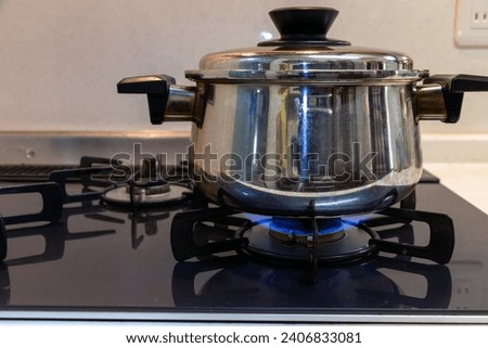 Heat a metal pot on a gas stove