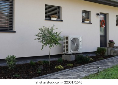 Heat pump or air conditioning in modern house of future using green electric energy, heat pump - efficient source of heat - Shutterstock ID 2200171545