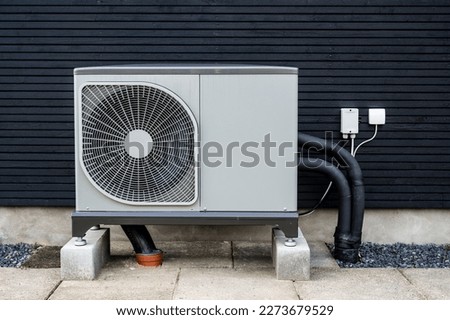 Heat pump in front og black building