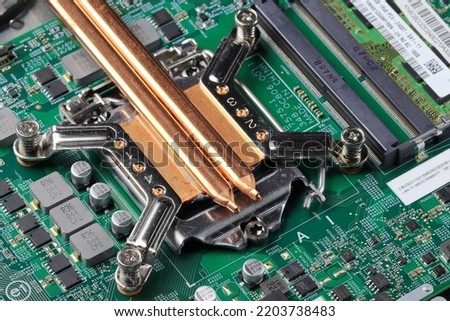 heat sink or heat pipe or computer processor cooler or radiator on notebook computer motherboard made from copper.