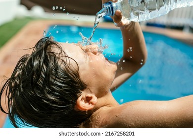 Heat wave. Splashing pour spill  throw water on his face with a bottle due to high temperatures in summer. Pool and water to withstand the heat wave in the holiday season. High temper. heat stroke