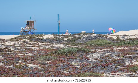 Heat waves ripple around a lifeguard tower on the hot, sandy beach in Newport Beach California - Shutterstock ID 725628955