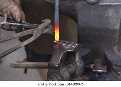 Heated metal and forceps on anvil - Powered by Shutterstock