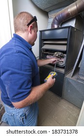 Heater Repair Man Testing Indoor Furnace.