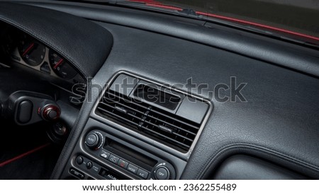 Heater vents on a black dashboard