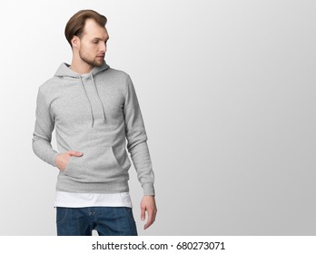 Heather Grey Hoodie On A Young Man In Jeans, Isolated, With Copy Space, Mockup.