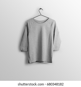 Heather Grey Pullover, Hoodie Mockup On Hanger, Hanging Against Empty Wall Background.