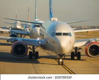 Heathrow Airport, London, England - February 2018: Close Up Head On View Of Passenger Planes Queuing Up For Take Off At London Heathrow