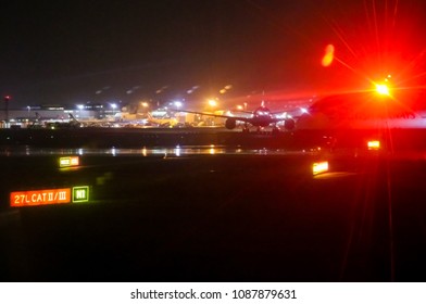 Heathrow Airport Tarmac On A Rainy Night With British Airways Plane Readying For Takeoff And Lights Reflecting Off Wet Surfaces - Blurred London UK 1 02 2018