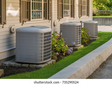 Heating And Air Conditioning Inverters On The Side Of A Condo 