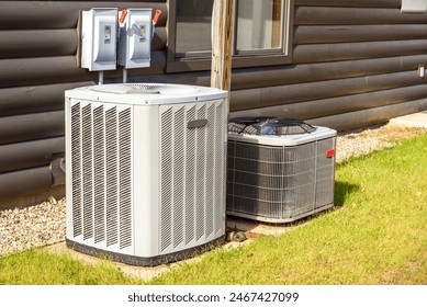 Heating and air conditioning system external units on grass in a house backyard