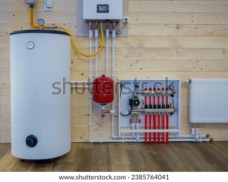 Heating boiler tank. Room with heating equipment. Gas boiler technologies. Heating system country house. Boiler tank at wooden wall. Gas equipment to maintain temperature. Engineering communications
