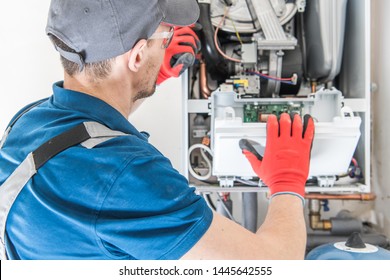 Heating Central Gas Furnace Issue. Technician Trying To Fix the Problem with the Residential Heating Equipment. - Shutterstock ID 1445642555