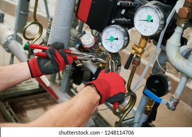 Heating Engineer Or Plumber In Boiler Room Installing Pipeline Manometer