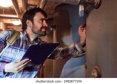 A Heating Fitter With A Checklist Checks The Condensing Boiler Of A Gas Heating System