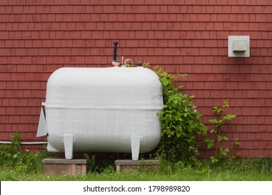 Heating fuel oil tank beside exterior wall. - Shutterstock ID 1798989820
