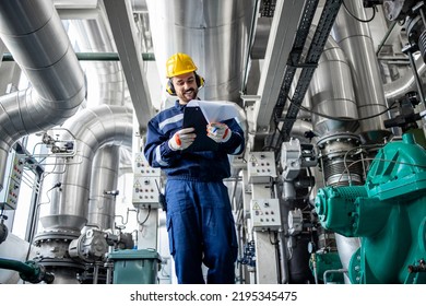 Heating Plant Supervisor Walking Through Boiler Pipeline Controlling Temperature And Gas Consumption.