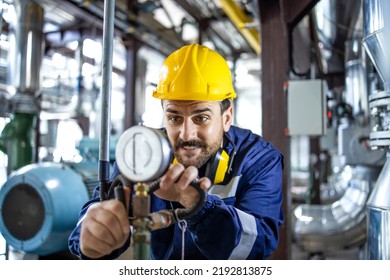 Heating Plant Worker Checking Water Temperature And Pressure In Boiler Room.