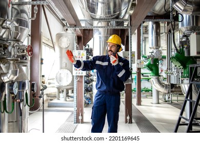 Heating Plant Worker Standing In Boiler Room And Communicating Via Radio Device.