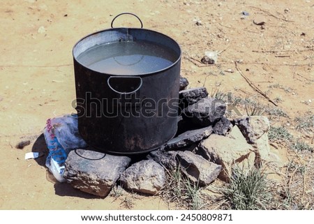 Heating water on rocks inside a camp for Syrian refugees in Qibb Ilyas (Qab Ilyas), Lebanon.