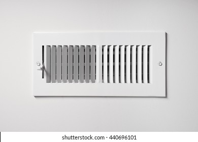 A Heating/cooling Vent Register On The Wall Of A Home, With Open/close Lever