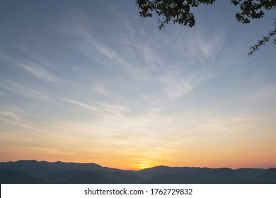 Heaven at early morning with copy space. Smooth orange blue gradient of dawn sky.Sunset, sunrise backdrop.Predawn clear sky with orange horizon and blue atmosphere.  Background of beginning of day. 