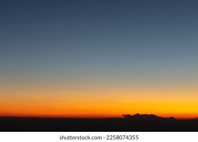 Heaven at early morning with copy space. Sunset, sunrise backdrop.Predawn clear sky with orange horizon and blue atmosphere. Smooth orange blue gradient of dawn sky.  - Shutterstock ID 2258074355