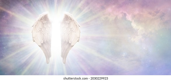 Heavenly Guardian Angel Concept Sky Banner - beautiful angelic wings with bright white light between floating in a pink blue ethereal sky background with copy space
