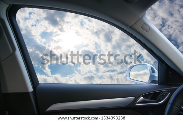 Heavenly landscape behind \
car window