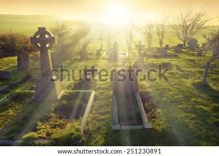 Heavenly light shining upon a old graveyard in England, United Kingdom.                               