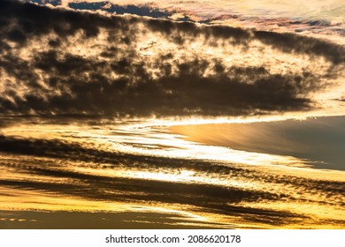 The heavenly light of the sun.Dramatic evening sky with clouds and rays of the sun.Sunlight at evening sunset or morning sunrise.Panoramic view of cirrus clouds in motion.Golden ray of the sun.Weather