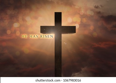 heavenly scene with Jesus Christ wooden cross elevated on the sky and He has risen text on a sunset background with warm, orange colors, dramatic light, clouds.Easter, resurrection, faith concept.  - Shutterstock ID 1067983016