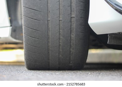 Heavily worn high performance tire - Shutterstock ID 2152785683